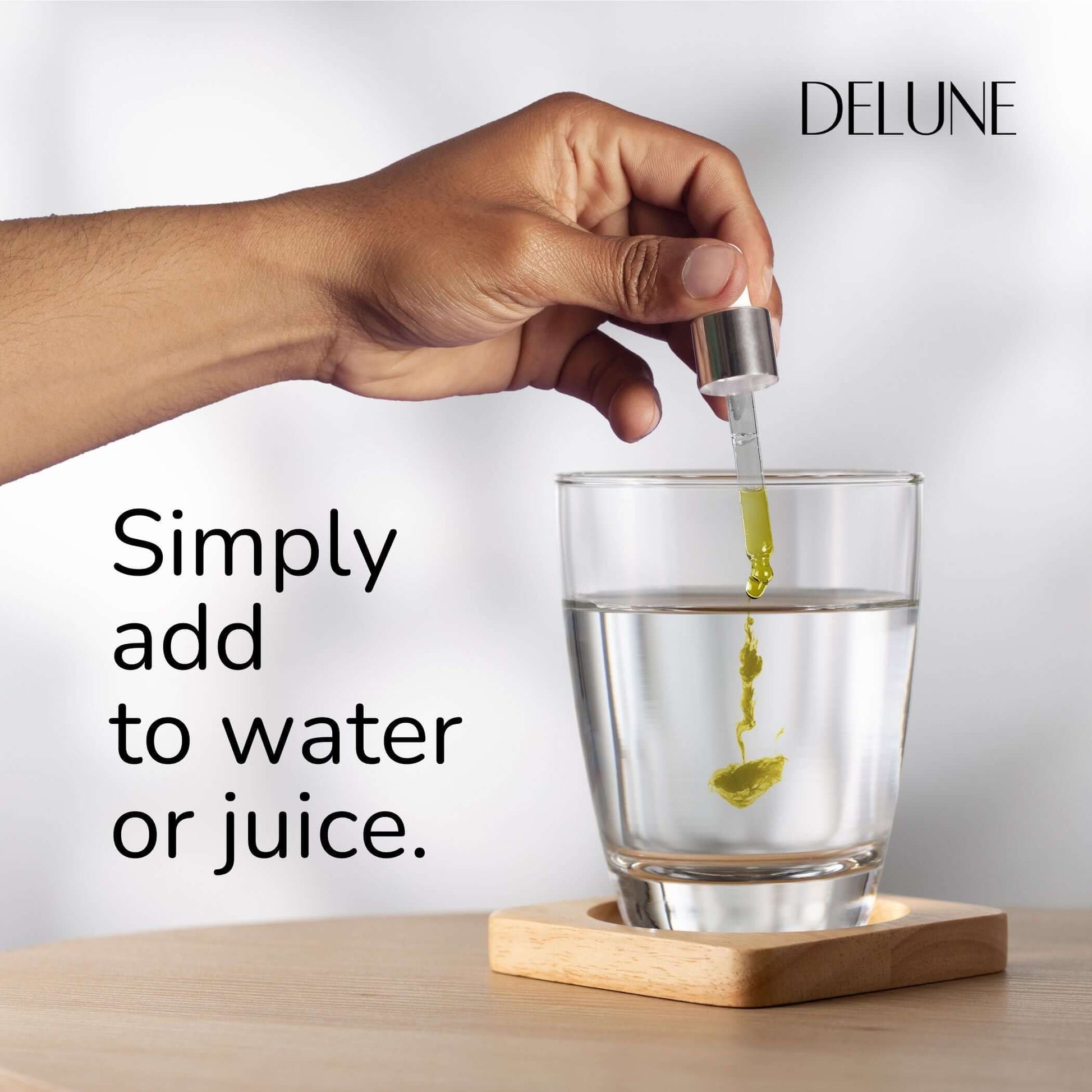 Adding Organic Turmeric Herbal Tincture to water with a dropper for vitality and wellness. Easy and effective Ayurvedic solution.