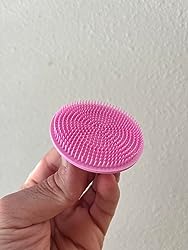Delune's pink face scrubber made from BPA-free, recyclable silicone-like material, featuring antimicrobial silver for effective skincare.