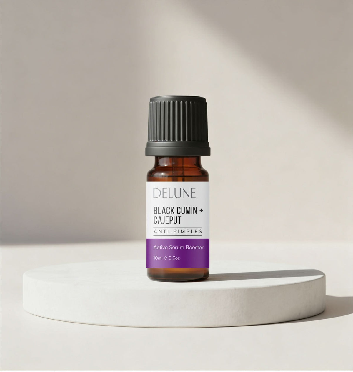 Face serum booster for pimples UAE – Delune Dubai Black Cumin + Cajeput Active Serum Booster 10ml on a white podium