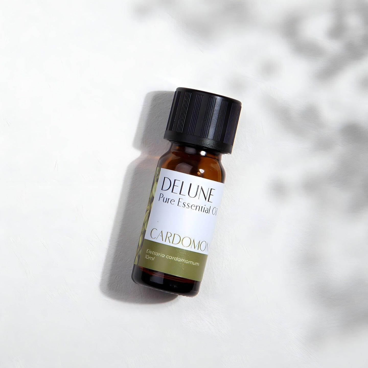Cardamom Pure Essential Oil bottle on a light background, offering a warm and spicy aroma for tranquility and clarity in meditation practices.