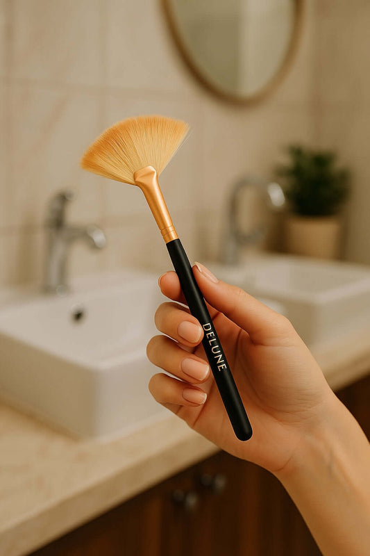 Delune clay mask fan brush in hand, ideal for precise spa-like skincare application.