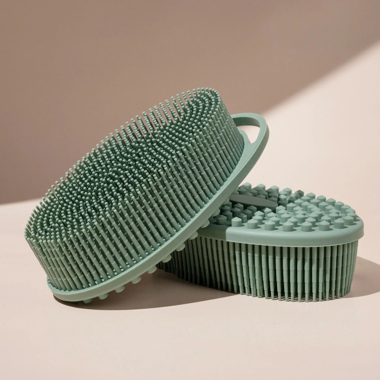 Delune Silicone Body Scrubber for gentle cleansing and massage, shown in green with bristle and massage sides, easy to hang and dry.