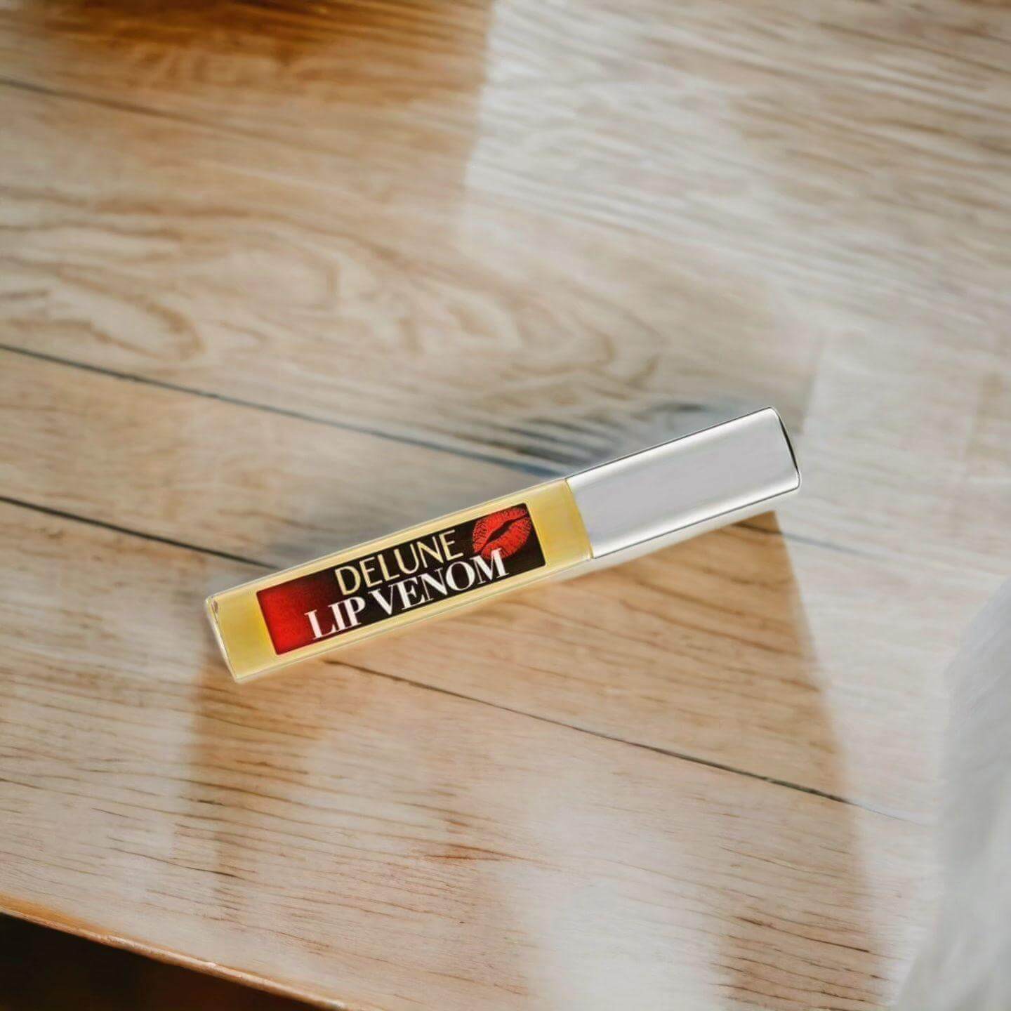 Lip Venom Plumping Glossy Balm on wooden surface, ultimate hydrating lip care for smooth, hydrated lips.