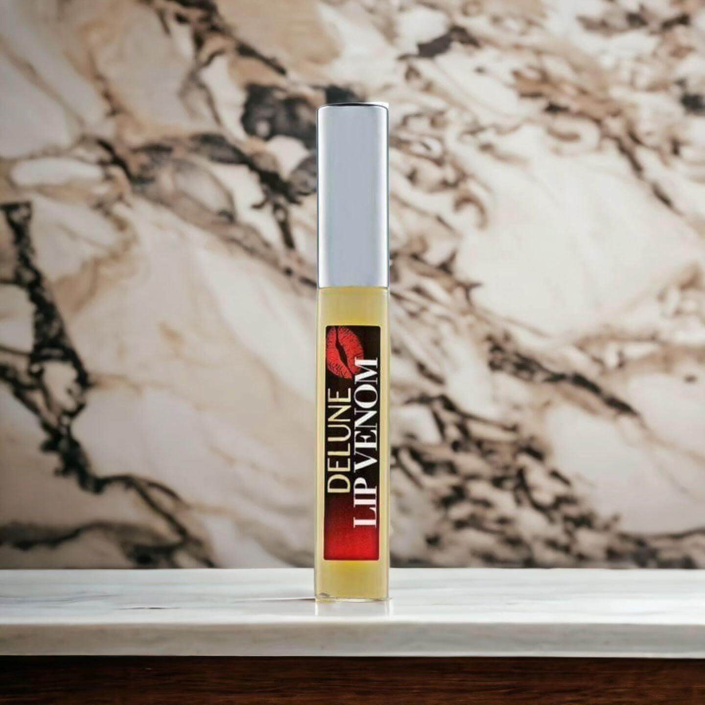 Lip Venom Plumping Glossy Balm in elegant packaging on a marble surface, promising ultimate lip hydration and smoothness.