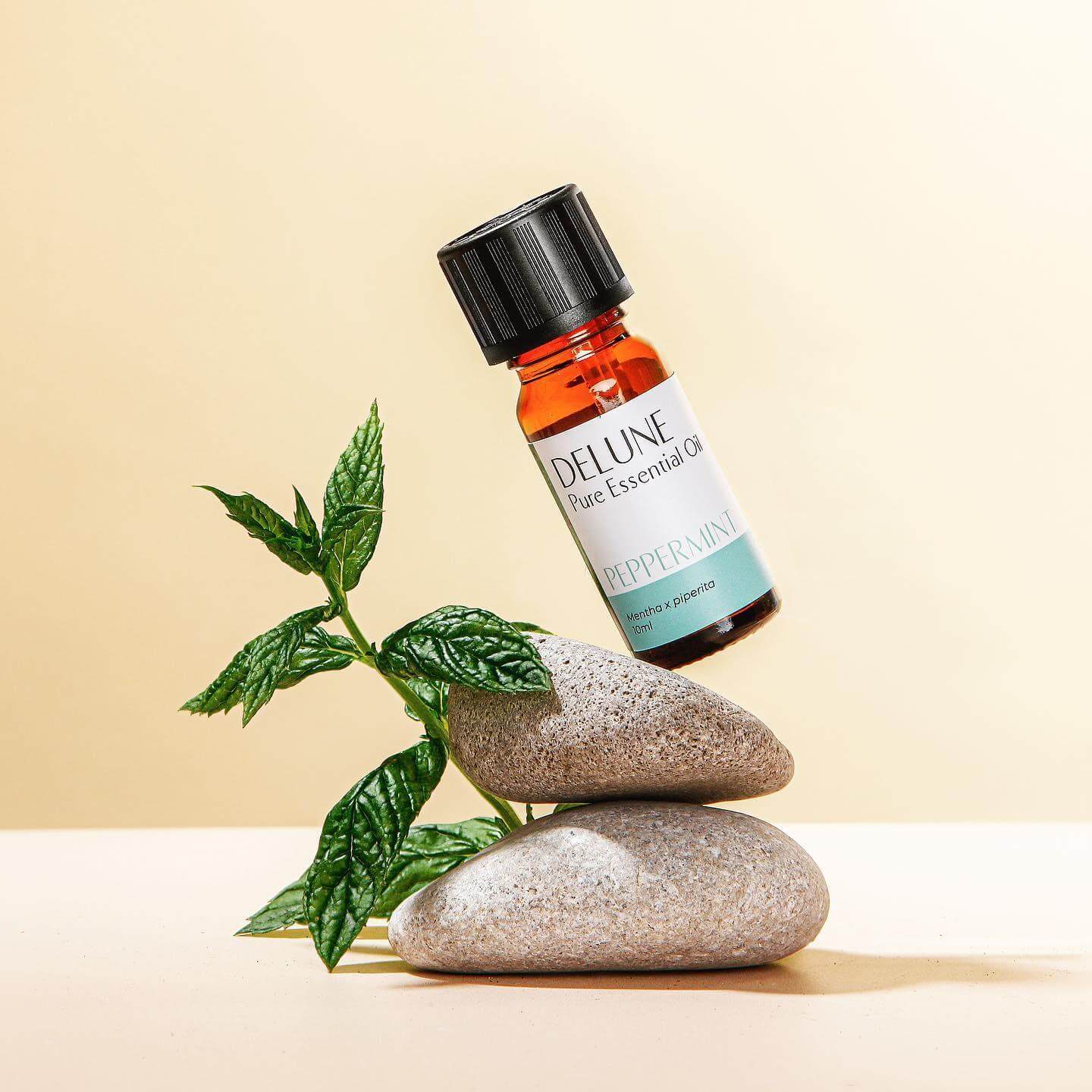 Peppermint Pure Essential Oil bottle with fresh peppermint leaves, highlighting its cooling aroma and invigorating properties.