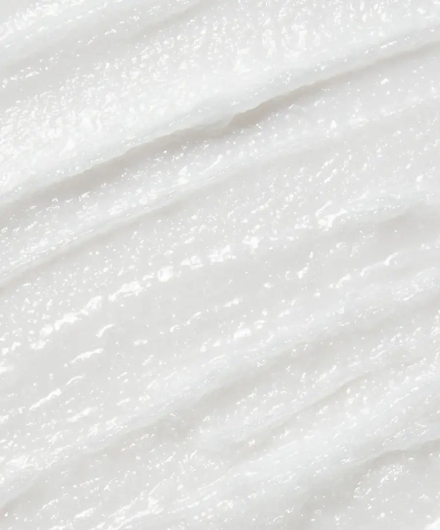 Close-up of creamy raw coconut cream cleanser texture, highlighting natural, unrefined virgin coconut oil and smooth consistency.