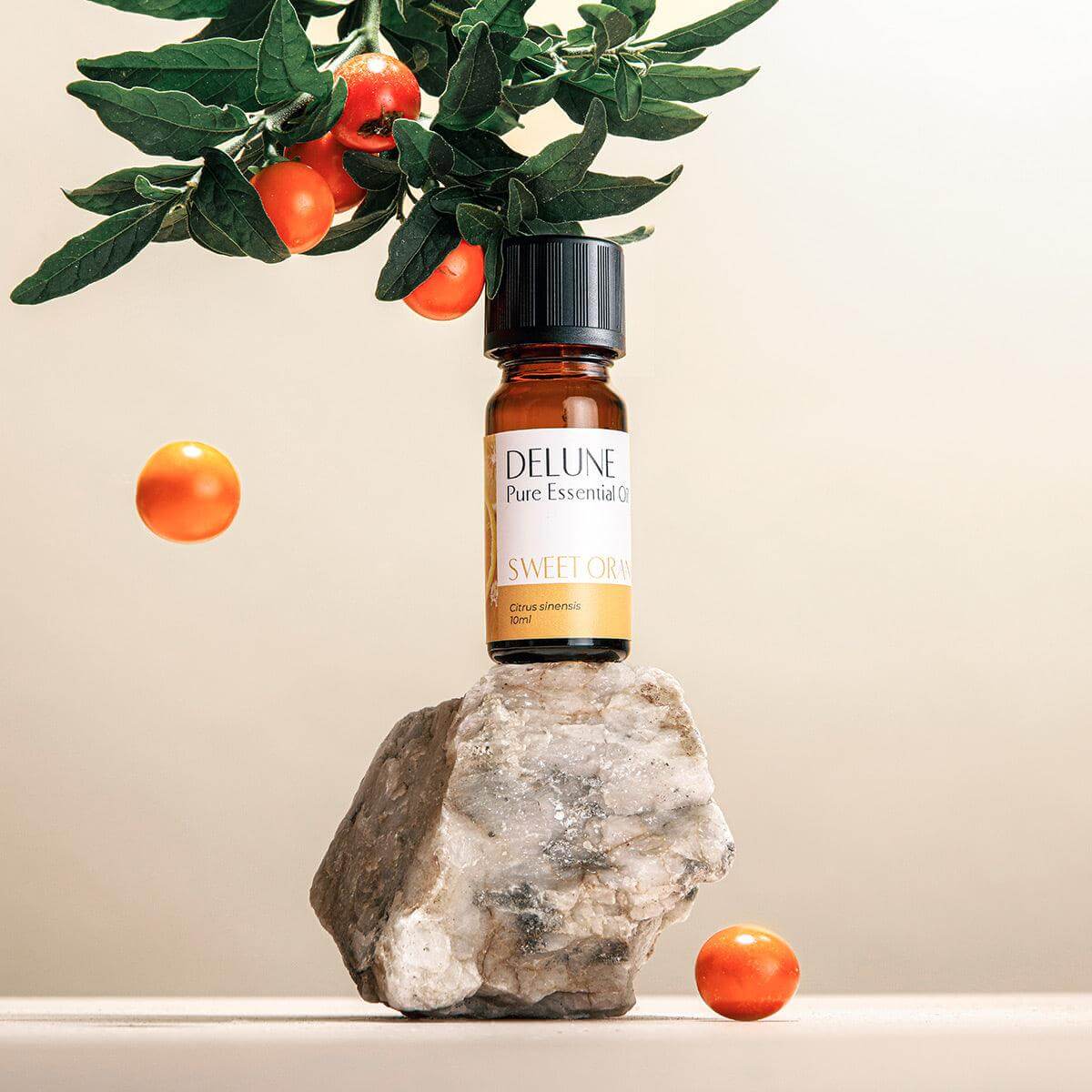 Alt Tag: Sweet Orange Pure Essential Oil bottle with fresh oranges, promoting uplifting and refreshing benefits.