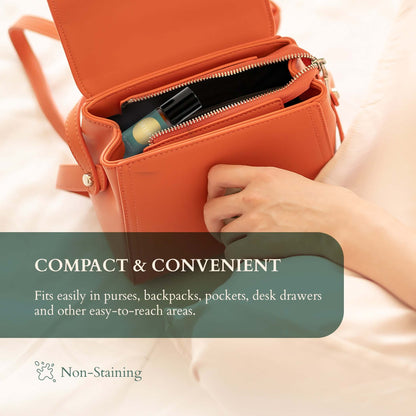 Essential oil roll-on in compact orange bag for easy storage and portability in purses, backpacks, and desk drawers.