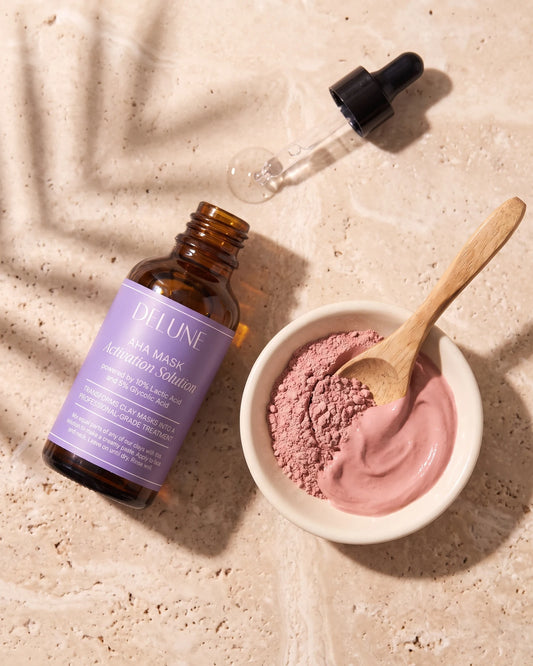 Mask activator UAE – Delune Dubai AHA Mask Activation Solution with its dropper beside a dish of rose clay