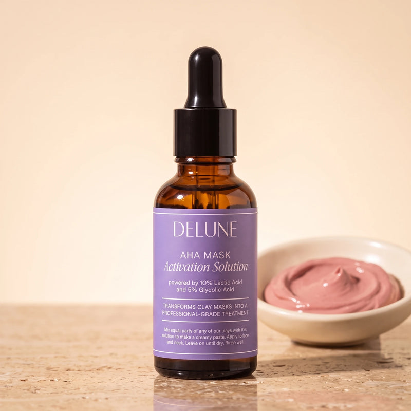 Mask activator UAE – Delune Dubai AHA Mask Activation Solution 30ml dropper bottle on travertine beside a dish of rose clay