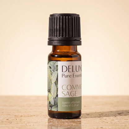 Delune Common Sage Pure Essential Oil, 10ml amber glass bottle on warm travertine stone