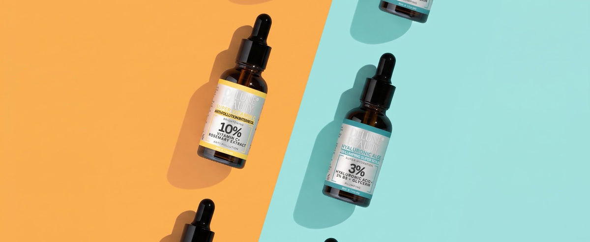 Delune Hyaluronic Aloe B5 and Super Vitamin C serums on a split orange and mint background