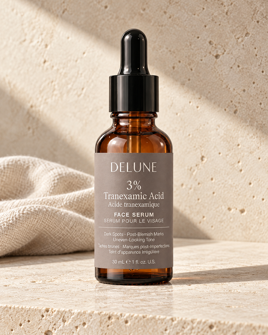 Delune Tranexamic Acid Serum on limestone with bone linen in warm directional sunlight