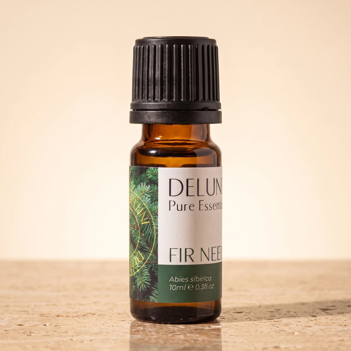 Fir Needle essential oil UAE – Delune Dubai Fir Needle Pure Essential Oil, 10ml amber glass bottle on warm travertine stone