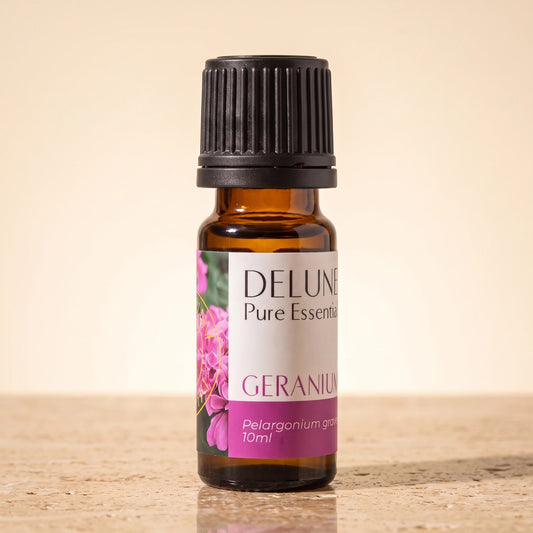 Delune Geranium Pure Essential Oil, 10ml amber glass bottle on warm travertine stone