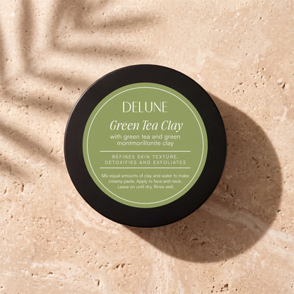 Clay face mask UAE – Delune Dubai Green Tea Clay Mask jar from above on warm travertine in soft window light