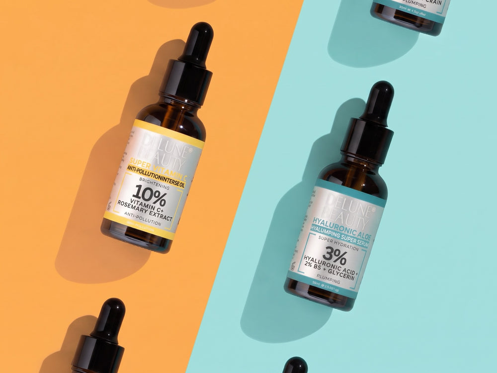 Super Vitamin C and Hyaluronic Aloe serums on orange and mint