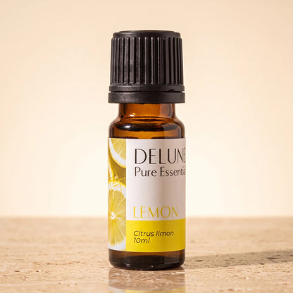 Lemon essential oil UAE – Delune Dubai Lemon Pure Essential Oil, 10ml amber glass bottle on warm travertine stone