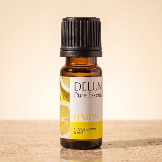 Lemon essential oil UAE – Delune Dubai Lemon Pure Essential Oil, 10ml amber glass bottle on warm travertine stone