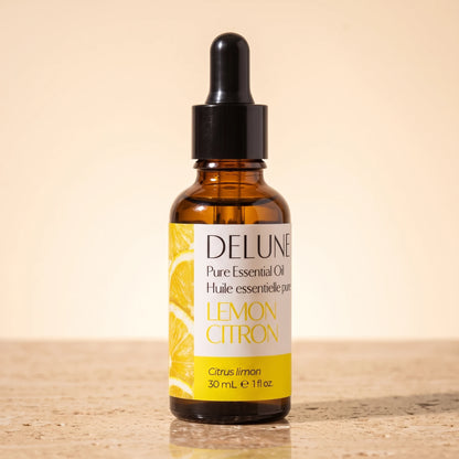 Lemon essential oil UAE – Delune Dubai Lemon Pure Essential Oil, 30ml amber glass dropper bottle on warm travertine stone