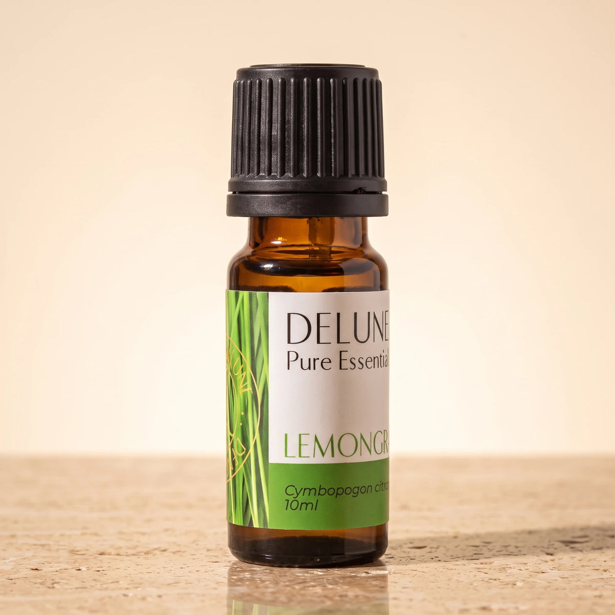 Lemongrass essential oil UAE – Delune Dubai Lemongrass Pure Essential Oil, 10ml amber glass bottle on warm travertine stone