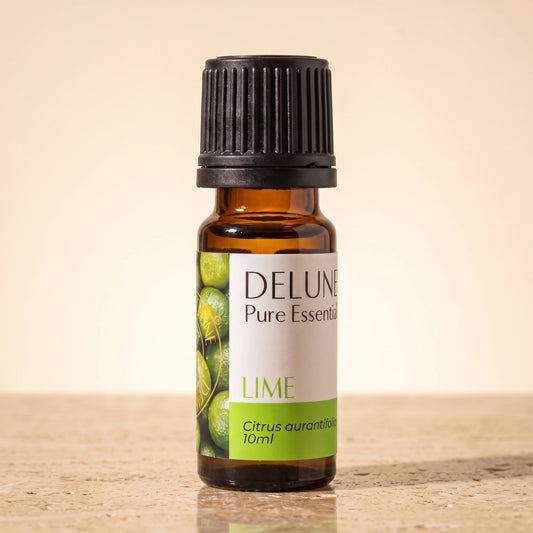 Lime essential oil UAE – Delune Dubai Lime Pure Essential Oil, 10ml amber glass bottle on warm travertine stone