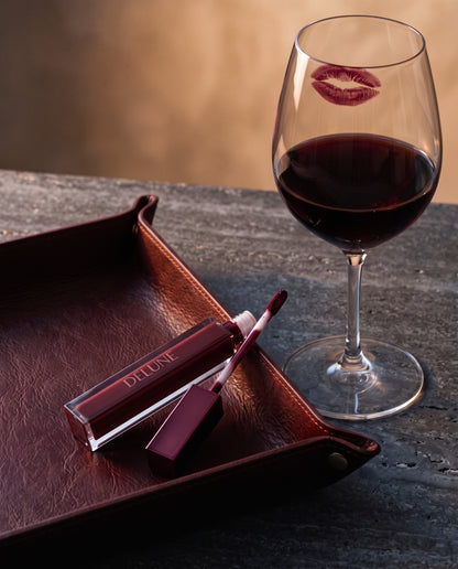 Matte lipstick UAE – Delune Dubai LuxMatte in Cabernet Kiss with a glass of cabernet