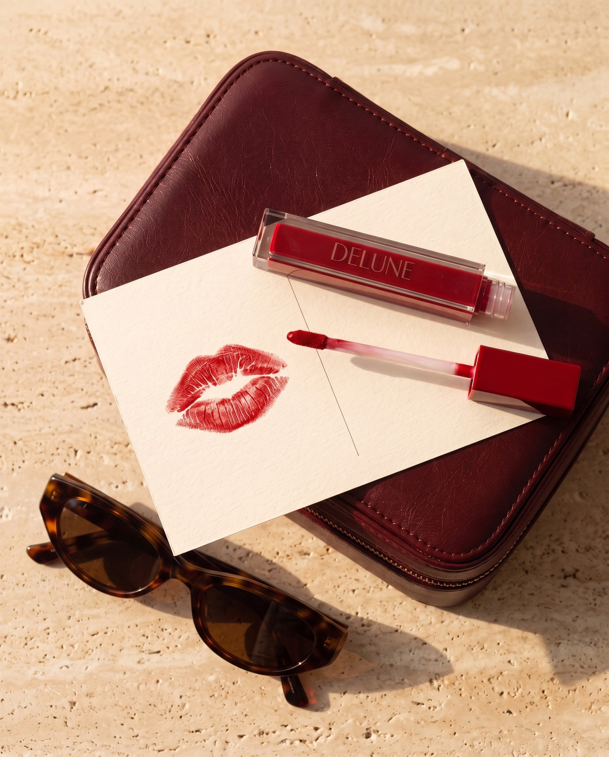 Matte lipstick UAE – Delune Dubai LuxMatte in Jet-Set Red with a red kiss on a postcard