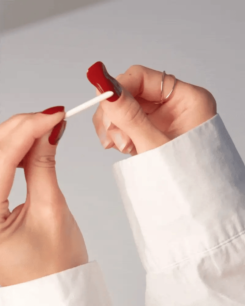 Applying a Delune non-UV nail wrap and filing the edge