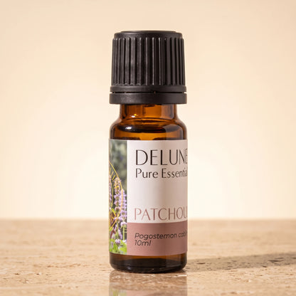 Patchouli essential oil UAE – Delune Dubai Patchouli Pure Essential Oil, 10ml amber glass bottle on warm travertine stone