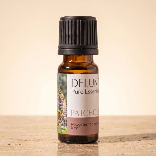 Patchouli essential oil UAE – Delune Dubai Patchouli Pure Essential Oil, 10ml amber glass bottle on warm travertine stone