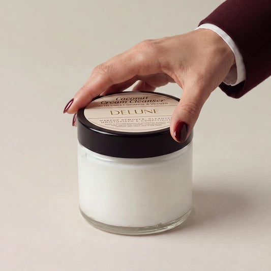Face cleanser UAE – Hand on the lid of Delune Dubai Coconut Cream Cleanser
