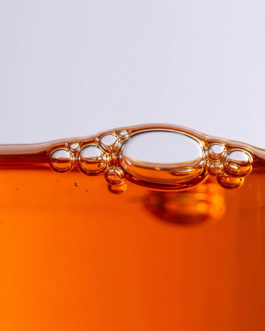 Face serum UAE – Delune Dubai Revive 49% Sea Buckthorn Oil Serum texture: macro of vivid orange sea buckthorn oil with
