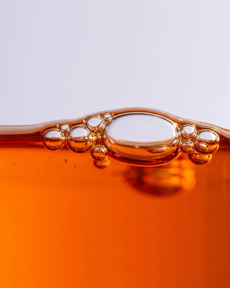 Face serum UAE – Delune Dubai Revive 49% Sea Buckthorn Oil Serum texture: macro of vivid orange sea buckthorn oil with
