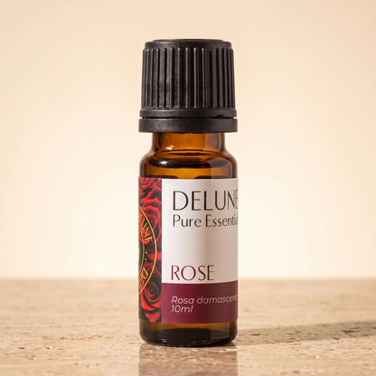 Rose essential oil UAE – Delune Dubai Rose Pure Essential Oil, 10ml amber glass bottle on warm travertine stone