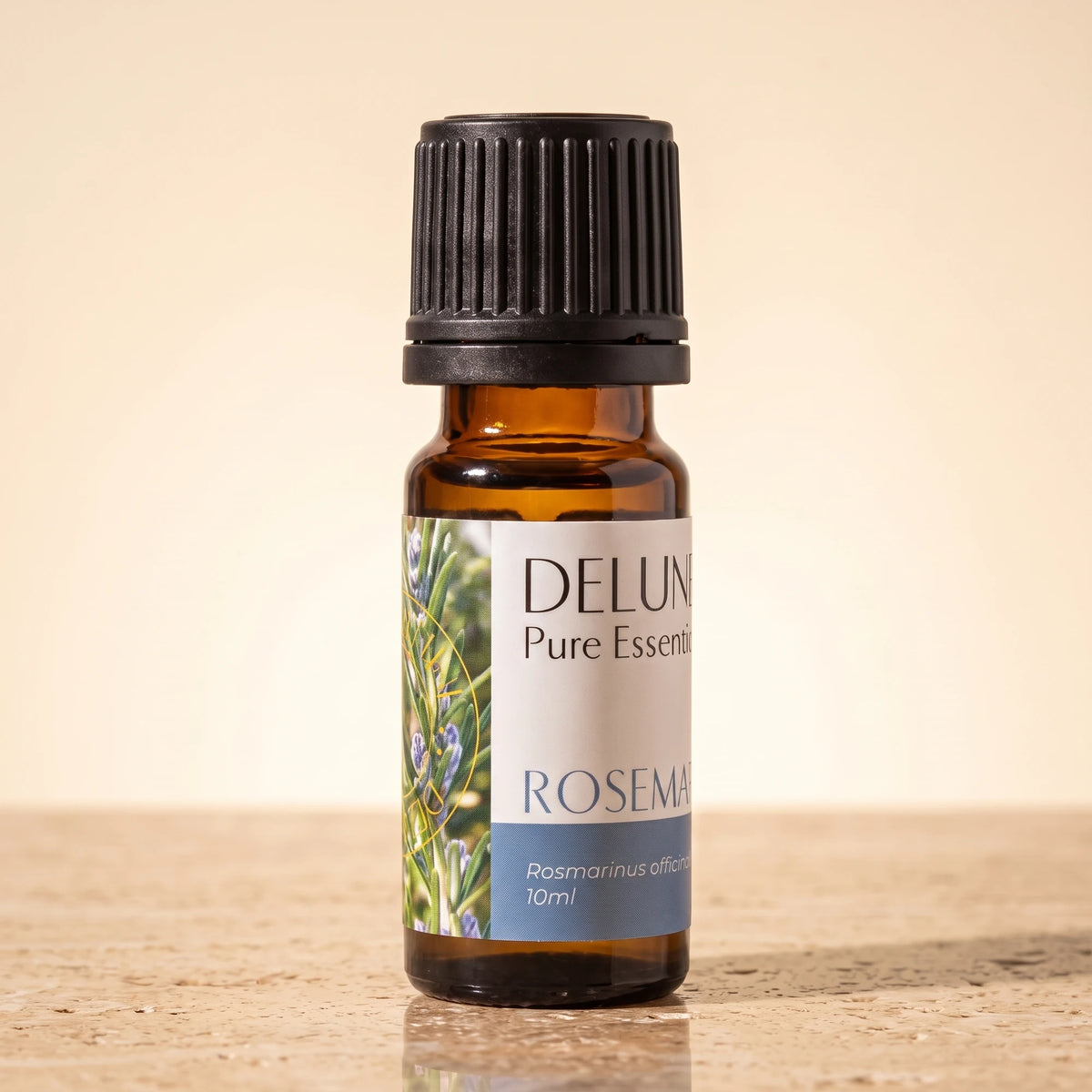 Rosemary essential oil UAE – Delune Dubai Rosemary Pure Essential Oil, 10ml amber glass bottle on warm travertine stone