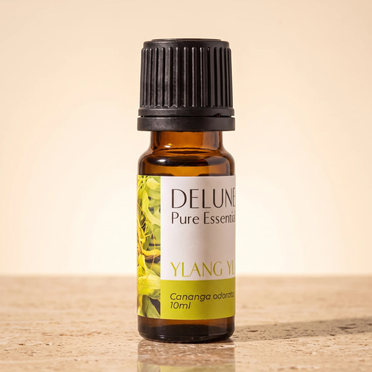 Ylang Ylang essential oil UAE – Delune Dubai Ylang Ylang Pure Essential Oil, 10ml amber glass bottle on warm travertine stone