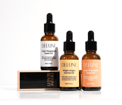 Delune Beauty oil collection featuring Virgin Raspberry Seed Oil, Argan Kernel Oil, and Pumpkin Seed Oil bottles.