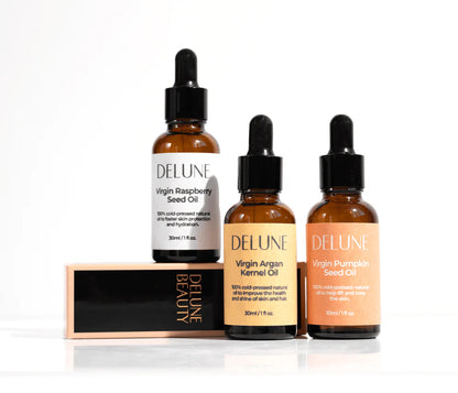 Delune beauty oils collection featuring Virgin Raspberry Seed, Argan Kernel, and Pumpkin Seed oil bottles on display.