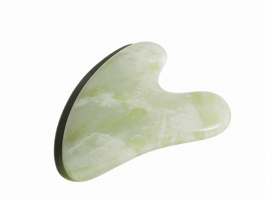 Jade Gua Sha facial tool for anti-aging and detoxifying massage, promoting skin circulation with calming jade properties.